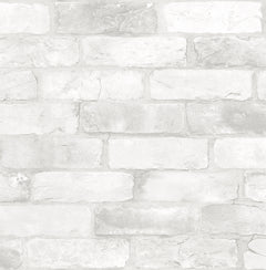 A close-up of York Wallcoverings Reclaimed Bricks Wallpaper, featuring white brick design with textured surface, visible mortar lines, and subtle shade variations for a realistic look.