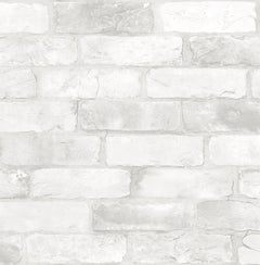 A close-up view of the Rustin Reclaimed Bricks Wallpaper by York Wallcoverings, featuring a whitewashed brick design with visible mortar lines and textured surfaces on each brick, highlighting subtle variations in color and shading.