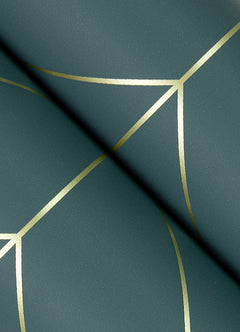 A close-up view of York Wallcoverings’ Sander Geometric Wallpaper shows a green surface adorned with intersecting gold geometric lines that form a modern, abstract pattern, while a dark shadow crosses the design diagonally.