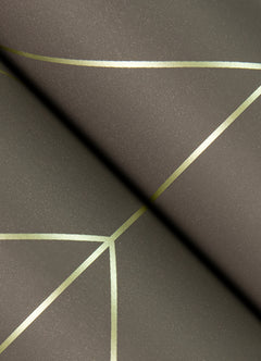 A close-up of York Wallcoverings’ Sander Geometric Wallpaper, featuring a textured dark surface with thin metallic gold lines that intersect to form abstract geometric patterns.
