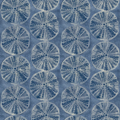Chesapeake Sea Biscuit Sand Dollar Wallpaper by York Wallcoverings features a symmetrical, repeating pattern of circular sand dollar-like shapes in shades of blue and white, set against a textured blue background.
