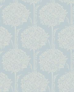 The Zaria Topiary Wallpaper by York Wallcoverings features a light blue background adorned with a repeating pattern of white, ornate, symmetrical floral bouquets and leafy branches, creating a classic and elegant vintage design.