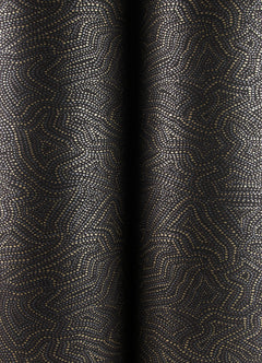 Close-up of Hollenback Dotted Abstract Wallpaper by York Wallcoverings, featuring a dark background with metallic gold dots forming abstract, maze-like lines and shapes. The wallpaper appears to have soft folds that create subtle shadows.