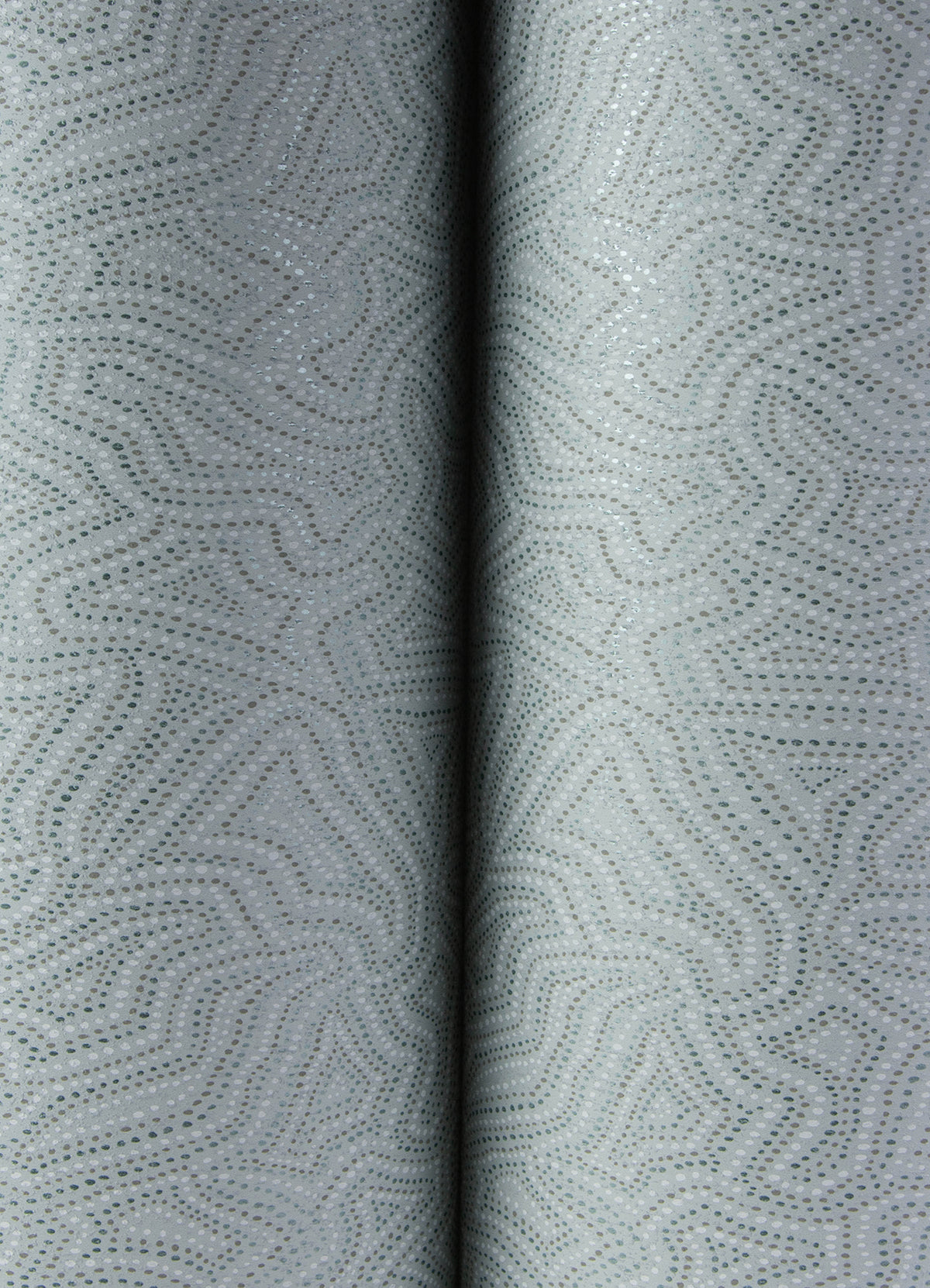 Close-up of Hollenback Dotted Abstract Wallpaper by York Wallcoverings in light gray, featuring a subtle dotted and wavy geometric pattern. Two folds run vertically down the center, creating a soft shadow between them.