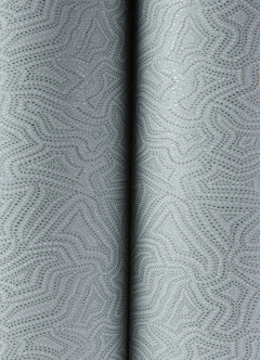 Close-up of Hollenback Dotted Abstract Wallpaper by York Wallcoverings in light gray, featuring a subtle dotted and wavy geometric pattern. Two folds run vertically down the center, creating a soft shadow between them.