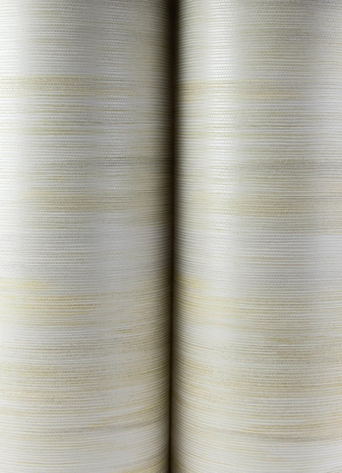 Close-up of two large, vertically standing rolls of Elysian Ikat Wallpaper by York Wallcoverings, featuring a textured off-white surface with subtle horizontal lines and faint yellowish hues. The rolls are positioned side by side, filling the frame.