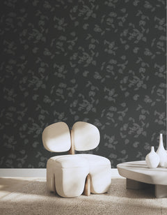 Myles Leaves Wallpaper featuring a pattern of delicate, light-colored leaf outlines against a dark gray background.