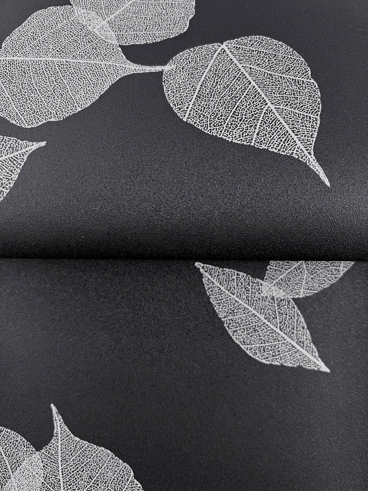 Myles Leaves Wallpaper featuring a pattern of white skeleton leaves on a black background.
