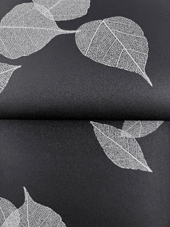 Myles Leaves Wallpaper featuring a pattern of white skeleton leaves on a black background.