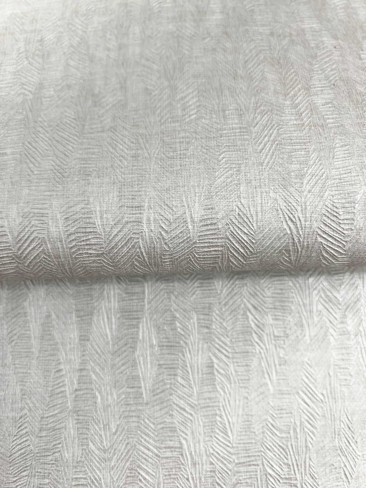 Bryson Feathered Texture Wallpaper in light gray with a repeating embossed pattern of vertical, feathered, chevron-like lines.