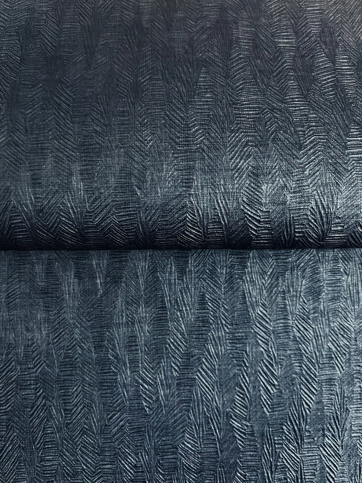 Bryson Feathered Texture Wallpaper in dark blue with an embossed, feathered herringbone pattern.
