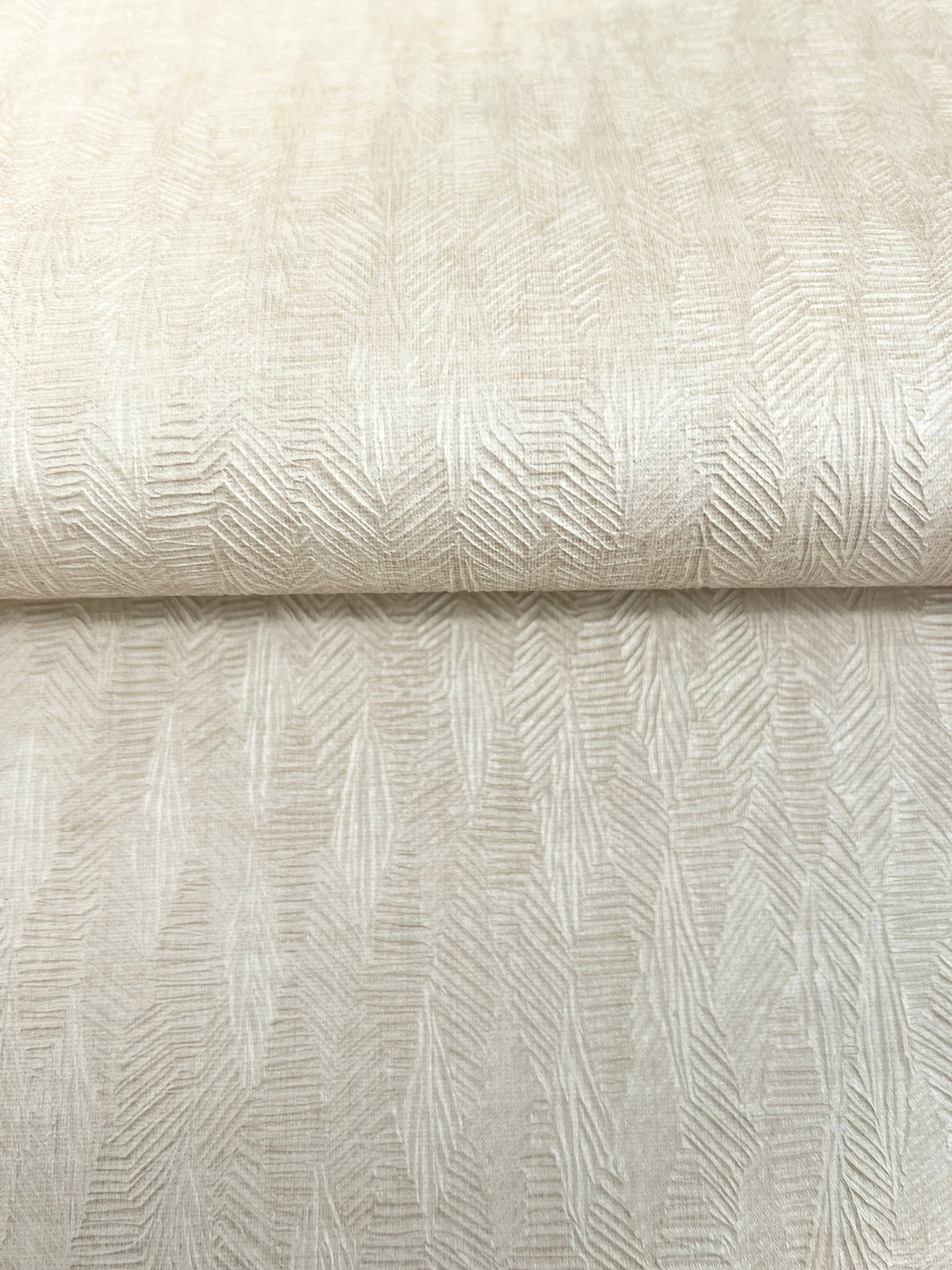 A roll of light beige Bryson Feathered Texture Wallpaper featuring a textured, repeating feathered or herringbone pattern.