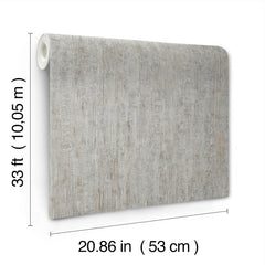 The Chesapeake Ramona Distressed Texture Wallpaper by York Wallcoverings is displayed upright. It measures 33 feet (10.05 meters) in length and 20.86 inches (53 centimeters) in width, featuring a gray, wood-like textured pattern.