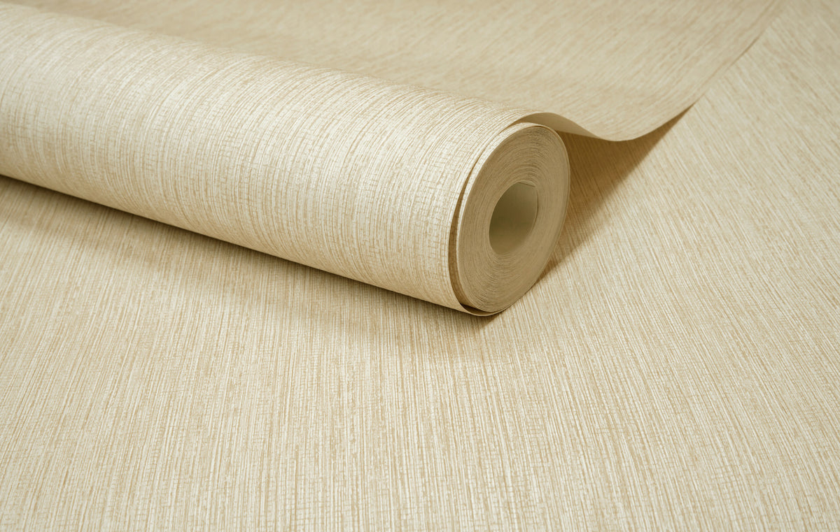 A close-up of the Chesapeake Elijah Texture Wallpaper by York Wallcoverings, shown partially unrolled on a flat surface to display its beige textured design.