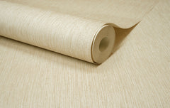 A close-up of the Chesapeake Elijah Texture Wallpaper by York Wallcoverings, shown partially unrolled on a flat surface to display its beige textured design.