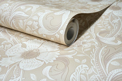 A close-up of the Chesapeake Liora Floral Trail Wallpaper by York Wallcoverings, featuring a textured floral and leaf pattern in beige, partially unrolled on a flat surface.