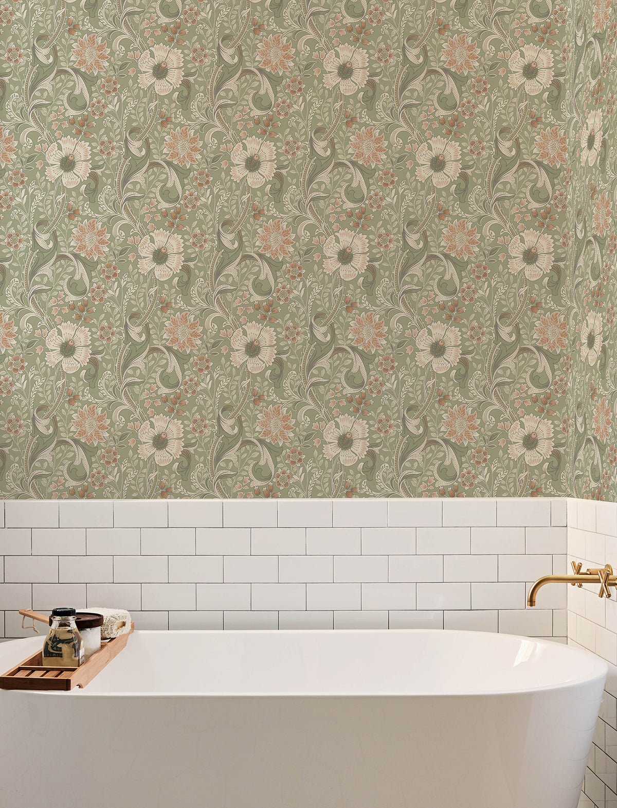 A white bathtub with a wooden tray is set against a wall featuring Chesapeake Liora Floral Trail Wallpaper by York Wallcoverings, paired with classic white subway tiles. A gold faucet is positioned on the right side above the tub.