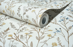 A partially unrolled roll of Chesapeake Laverne Wildflowers Wallpaper by York Wallcoverings, featuring a delicate floral pattern in shades of brown, yellow, and blue on a white background.