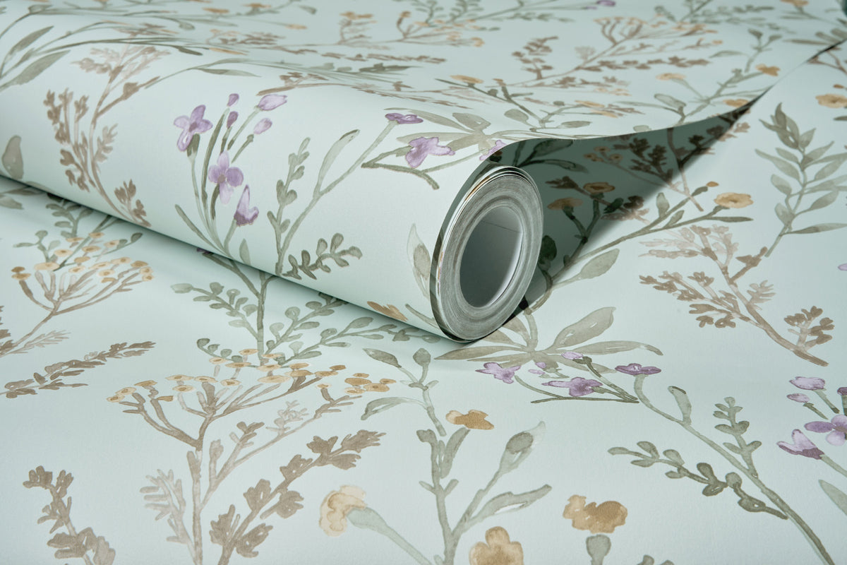 The Chesapeake Laverne Wildflowers Wallpaper by York Wallcoverings features a botanical pattern with green leaves and purple and yellow flowers on a light background.
