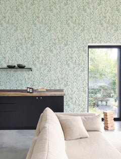 Modern living room with a beige sofa, black cabinets, wooden countertop, and Chesapeake Laverne Wildflowers Wallpaper by York Wallcoverings. A large window reveals a green garden outside, and a stack of wooden blocks sits on the floor near the window.