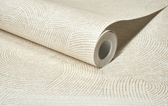 A partially unrolled roll of Chesapeake Harrison Swirling Geometric Wallpaper by York Wallcoverings in beige, featuring a subtle, textured pattern of curved and straight lines, displayed on a flat surface.
