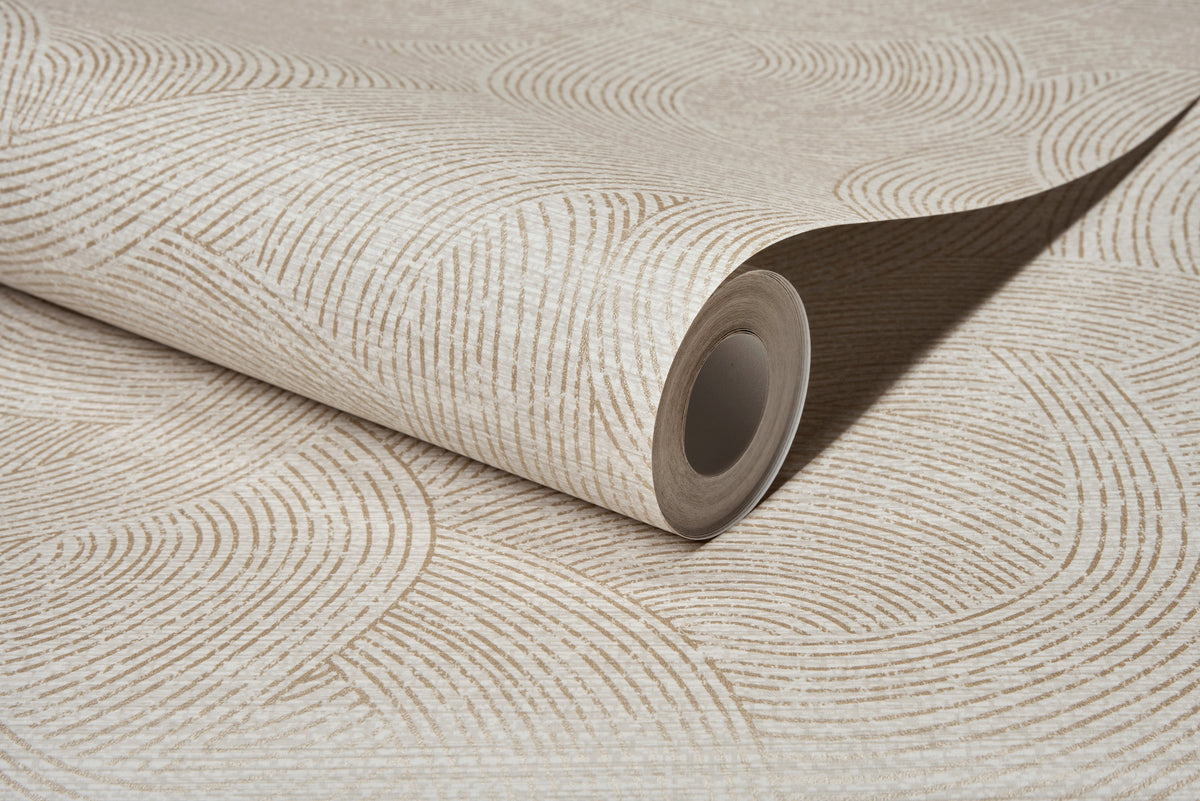 A close-up of a rolled sheet of Chesapeake Harrison Swirling Geometric Wallpaper by York Wallcoverings, featuring a beige and off-white wavy geometric pattern that highlights the textured surface and the open end of the roll.