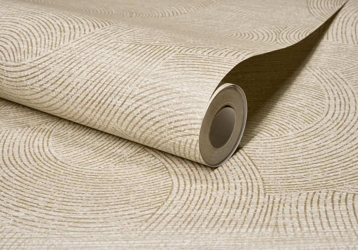 A partially unrolled roll of Chesapeake Harrison Swirling Geometric Wallpaper by York Wallcoverings, featuring a beige hue with a textured circular line pattern on a coordinated background.