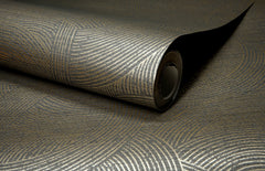 A close-up of a roll of York Wallcoverings Chesapeake Harrison Swirling Geometric Wallpaper, featuring a metallic geometric pattern of curved, concentric lines on a dark background.