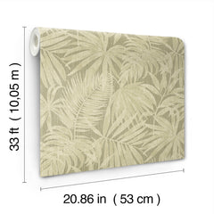 The Chesapeake Sonny Fronds Wallpaper by York Wallcoverings features a light beige background with a subtle tropical palm leaf pattern. Each roll measures 33 feet (10.05 meters) in length and 20.86 inches (53 cm) in width.