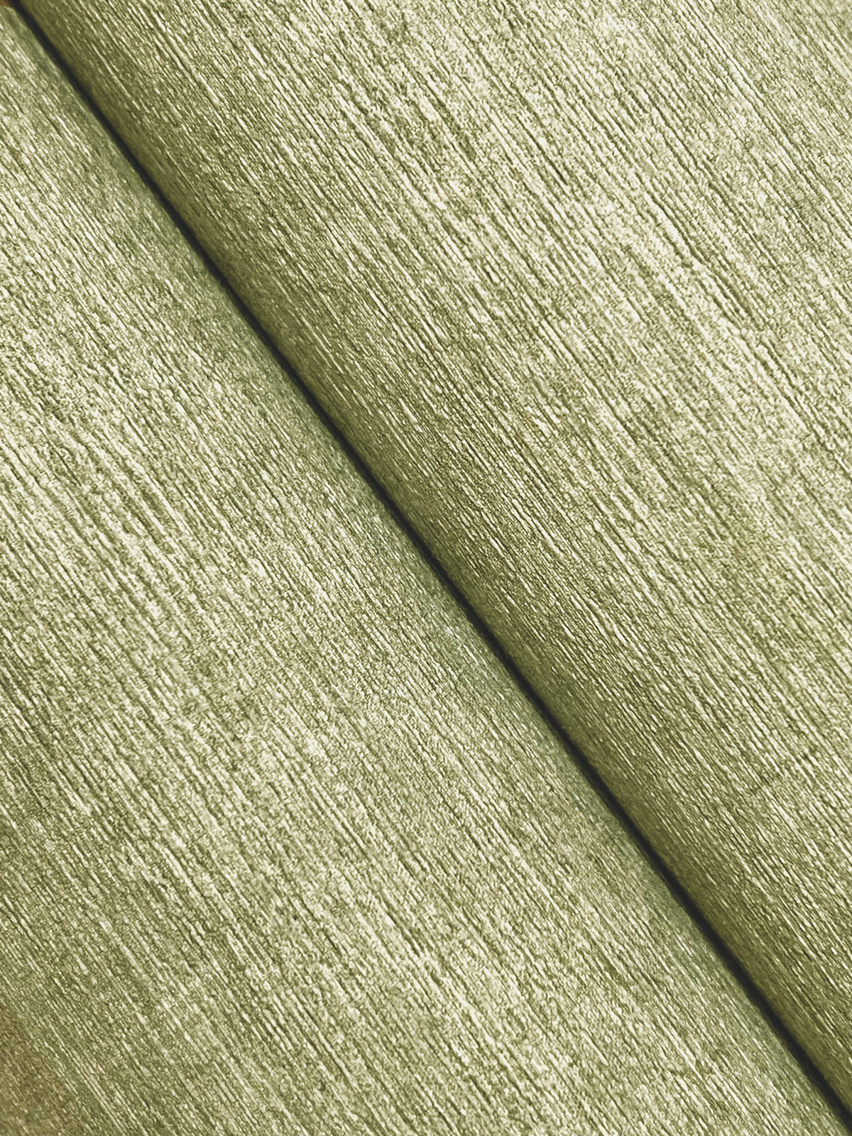 Close-up of two parallel strips of Chesapeake Tansy Distressed Wallpaper by York Wallcoverings, featuring a textured, light greenish surface, running diagonally from top left to bottom right.