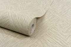 A roll of Chesapeake Hollis Textured Diamond Wallpaper by York Wallcoverings, featuring a beige geometric texture, is partially unrolled on a matching surface.