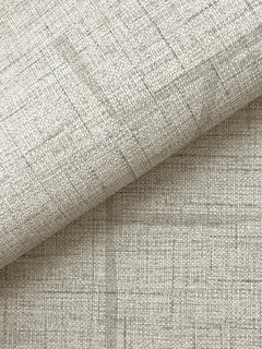 Close-up of York Wallcoverings’ Lyle Abstract Geometric Wallpaper in a light beige shade, showcasing its subtle woven texture and faint intersecting lines, with the wallpaper folded diagonally to reveal both the patterned surface and the underside.