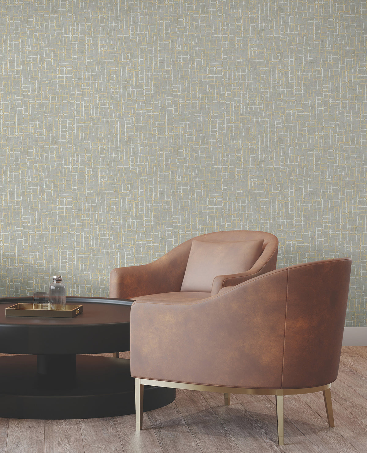 A modern seating area with a brown armchair, a round black coffee table, and a textured light-colored wall adorned with the Rian Linear Abstract Wallpaper by York Wallcoverings, featuring a subtle geometric pattern. Light wood flooring completes the contemporary look.