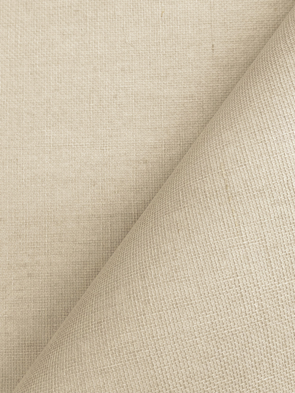 Woven Linen Wallpaper by York Wallcoverings features a beige textured surface with a subtle grid pattern, shown partially folded at a diagonal to create gentle shadows that highlight the intricate weave details.
