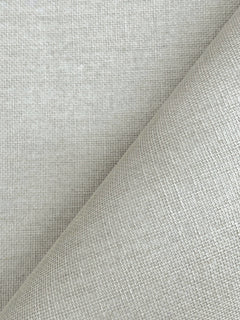 Close-up of Woven Linen Wallpaper by York Wallcoverings in light gray, featuring a textured, grid-like pattern. One section is rolled diagonally across the image, highlighting the intricate weave and subtle sheen of the wallpaper.