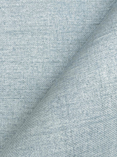 Close-up of York Wallcoverings’ Woven Linen Wallpaper in light blue, showcasing its textured woven surface with a visible diagonal fold and subtle variations in color and pattern.