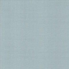 The Woven Linen Wallpaper by York Wallcoverings features a light blue fabric texture with a subtle weave pattern, creating the look of a soft, smooth textile surface.