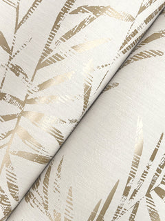 A close-up of Allerton Bamboo Wallpaper, showcasing a beige design with overlapping abstract gold metallic leaves on a textured, light background.