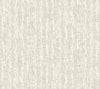 Juju Wallpaper by York Wallcoverings features a light gray textured finish with a vertical, abstract pattern reminiscent of tree bark or rough brush strokes. The subtle, monochromatic design offers a natural and organic ambiance.