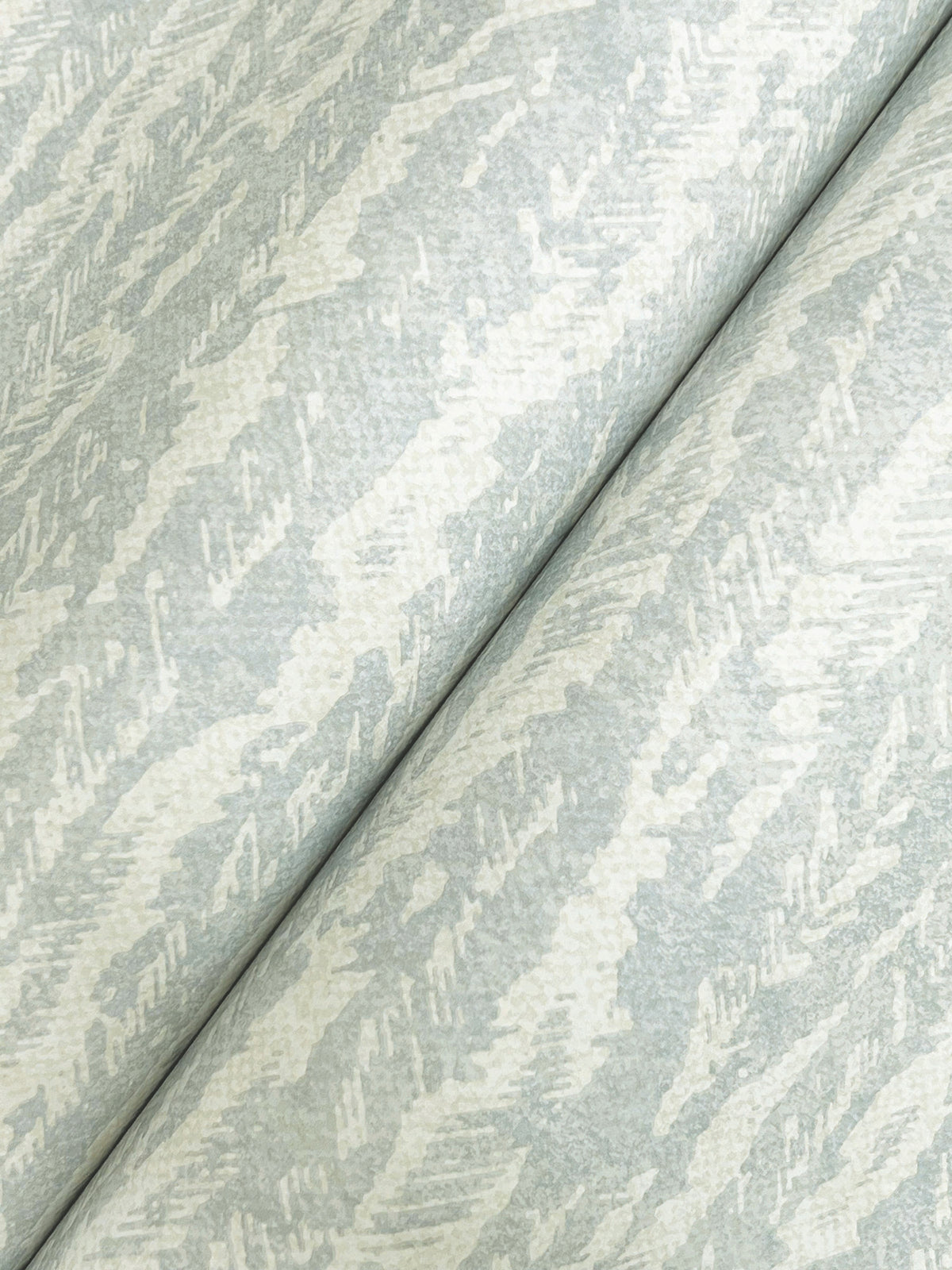Close-up of Juju Wallpaper by York Wallcoverings in light gray and off-white, featuring a subtle, abstract wavy pattern. The wallpaper is shown folded diagonally, highlighting its soft texture and elegant design.