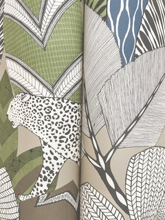 The Namiri Wallpaper by York Wallcoverings showcases a spotted leopard set among abstract, stylized leaves and plants rendered in green, beige, brown, white, and blue tones.