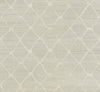 Tonga Wallpaper by York Wallcoverings features a light beige fabric-like surface adorned with a subtle geometric pattern of interlocking diamond shapes. The slightly raised, textured design is minimalist and repetitive, offering a modern and elegant aesthetic.