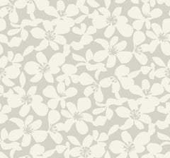 Free Spirit Wallpaper by York Wallcoverings features a seamless pattern of light cream-colored flowers with overlapping petals on a pale gray background, creating a soft and delicate floral design.