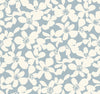 Transform your space with the Free Spirit Wallpaper by York Wallcoverings, featuring a seamless pattern of white abstract flowers scattered across a soft blue background for a simple and elegant floral design.