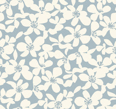 Transform your space with the Free Spirit Wallpaper by York Wallcoverings, featuring a seamless pattern of white abstract flowers scattered across a soft blue background for a simple and elegant floral design.