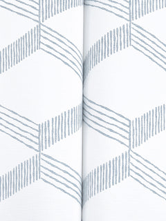 Close-up of Palisades Paperweave Wallpaper by York Wallcoverings in light gray, featuring a repeating geometric pattern of diagonal lines that create zigzags. A vertical seam is visible down the center where two pieces meet, set against a white background.