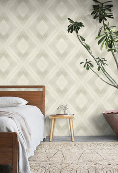 A bedroom wall featuring Ballad Wallpaper, which displays a large-scale, soft-edged diamond pattern in neutral tones.