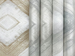 Ballad Wallpaper rolls arranged side by side, featuring a large-scale, shimmering chevron or diamond pattern in shades of white, gray, and tan.