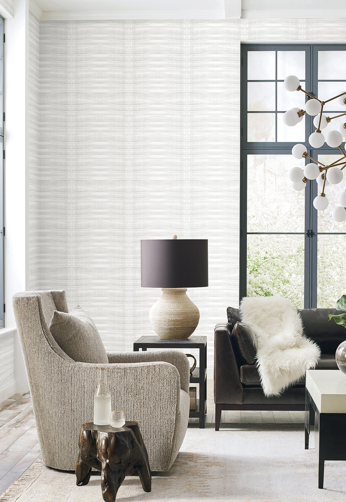 Grey Stone Wallpaper by York Wallcoverings in light grey with a horizontal wavy texture installed in a modern living room.