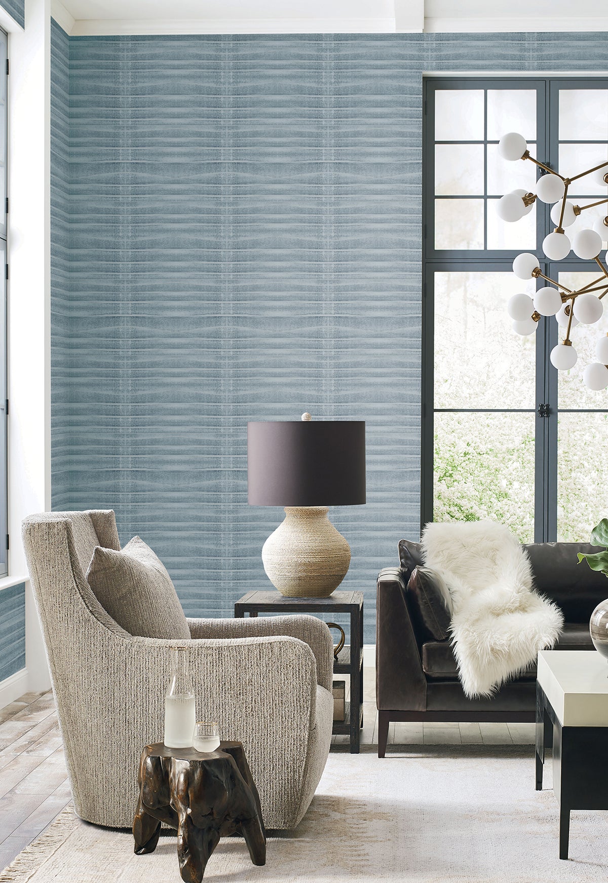 Grey Stone Wallpaper by York Wallcoverings on a living room wall, featuring a textured grey surface with a subtle horizontal ribbed pattern.